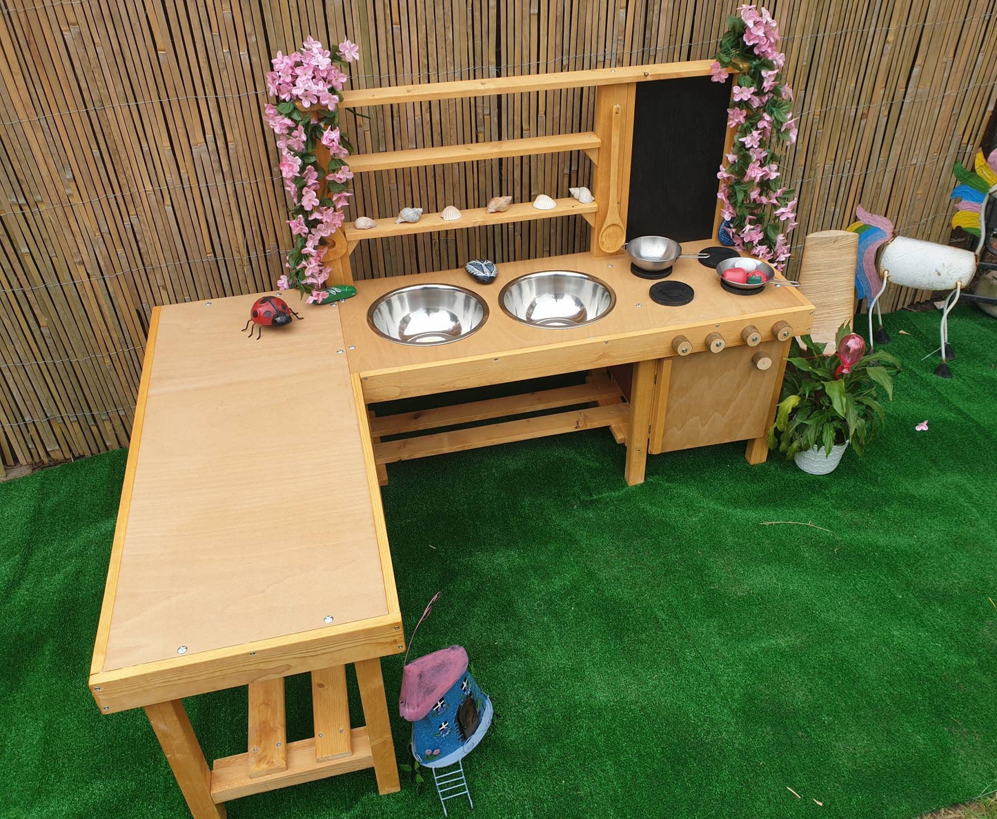 L shape mud kitchen with oven, blackboard and large worktop